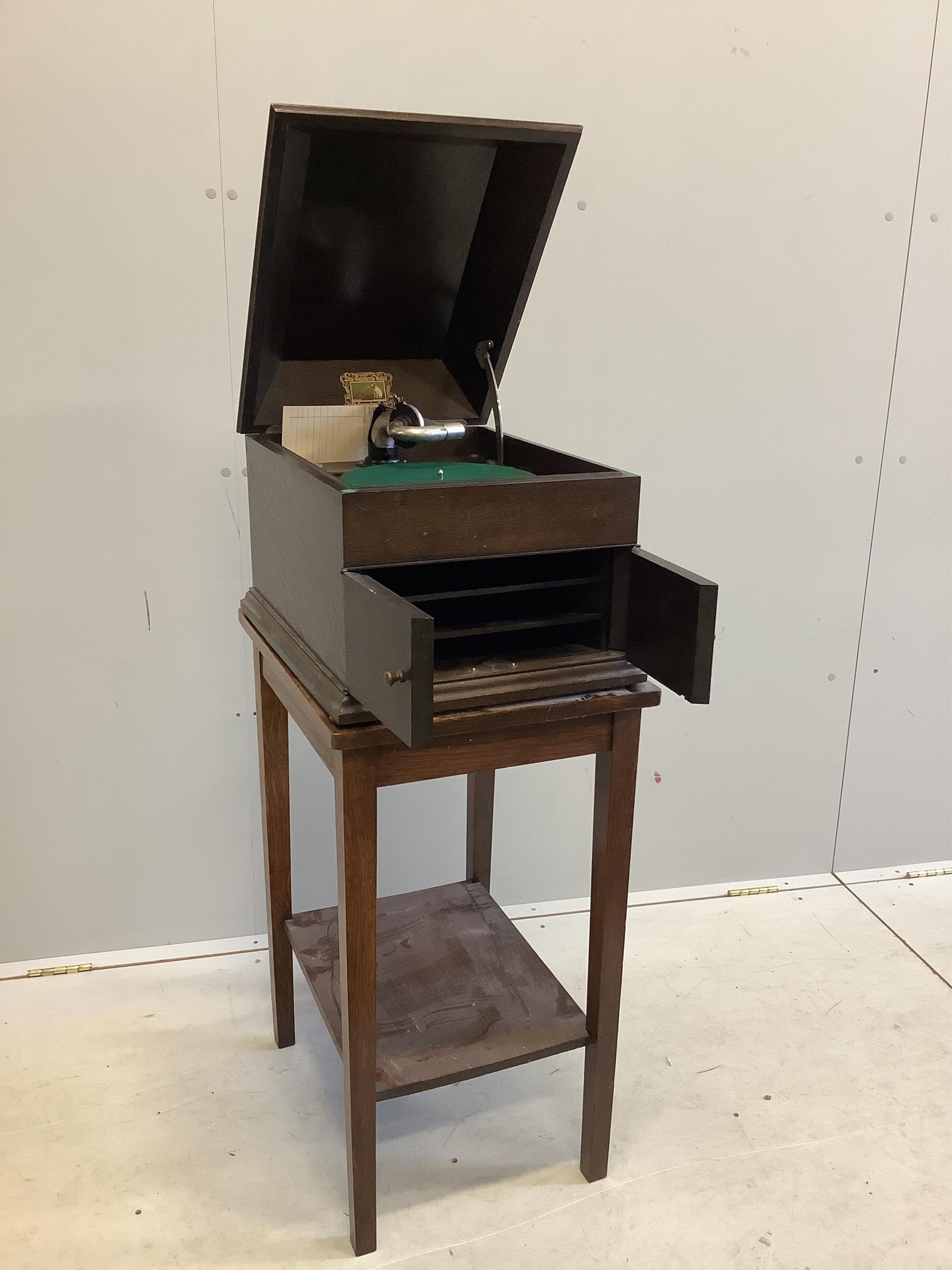 An HMV oak cased table-top gramophone on associated stand together with a collection of 78rpm records. Condition - fair